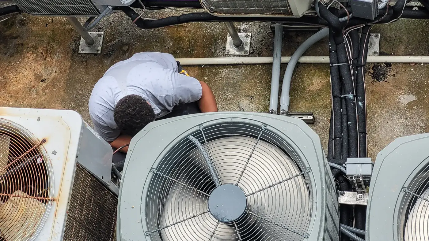 HVAC technician performing maintenance on commercial equipment
